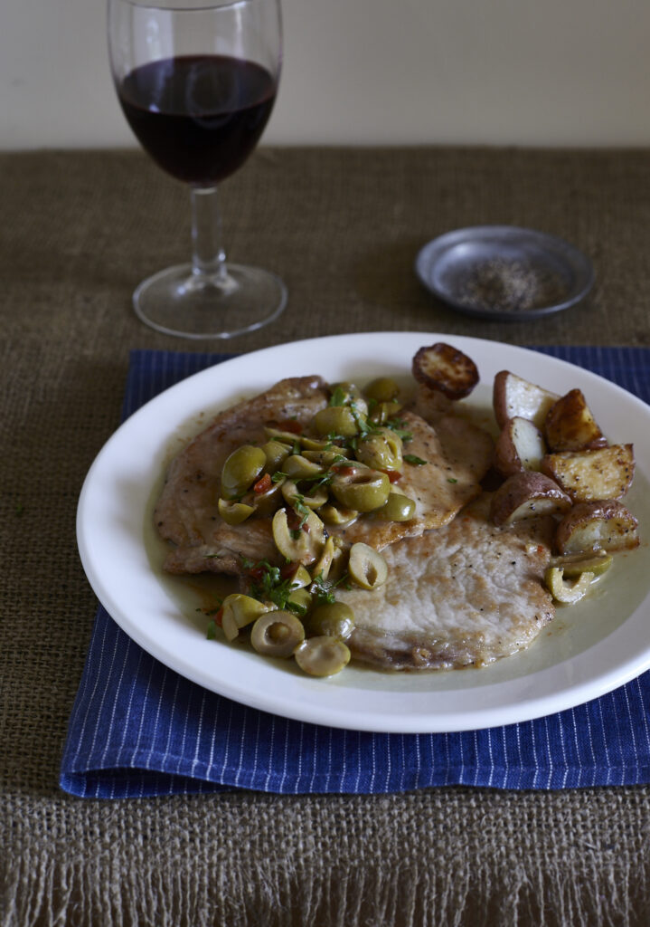 a plate of food and a glass of wine