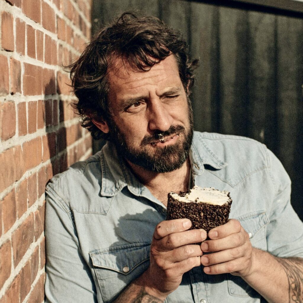 a man holding a cupcake