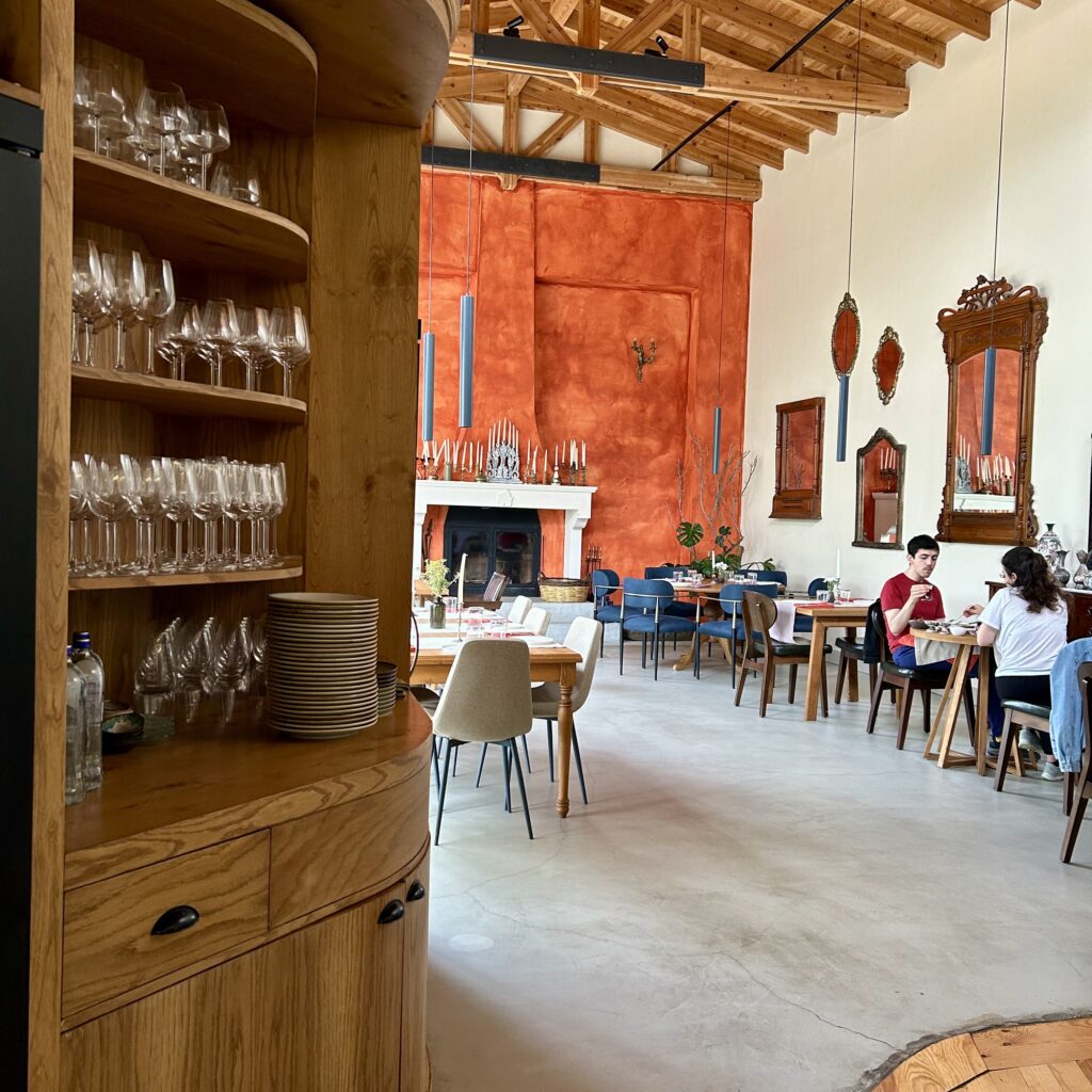 A room with a wood shelf and a wood cabinet with wine glasses