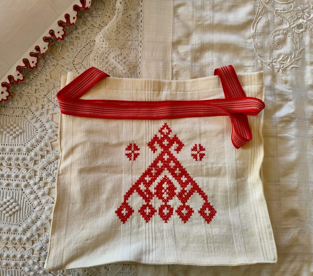 A white bag with red embroidery