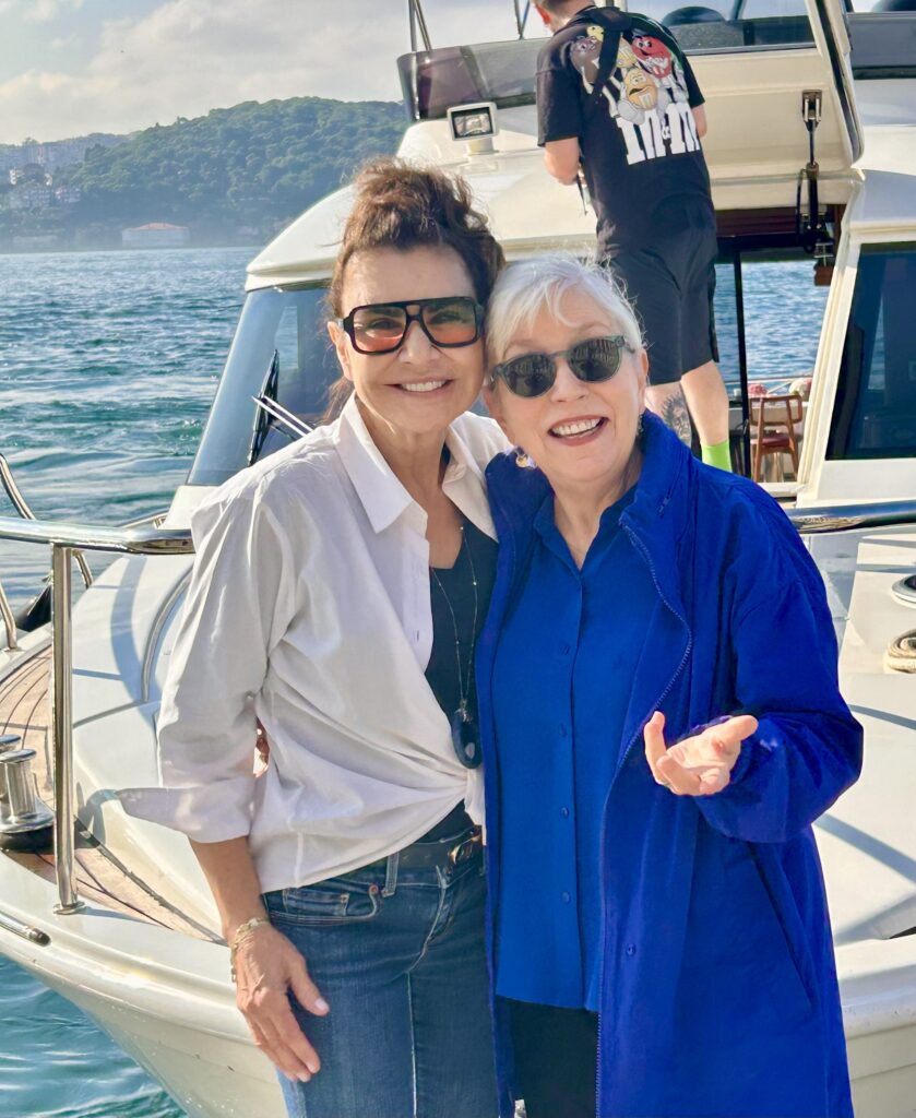 Two women standing on a boat