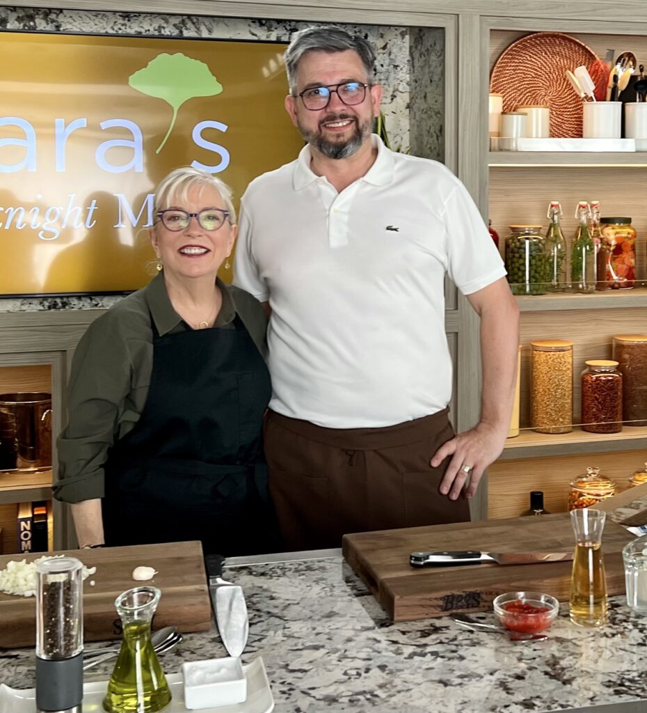 A man and woman standing in a kitchen