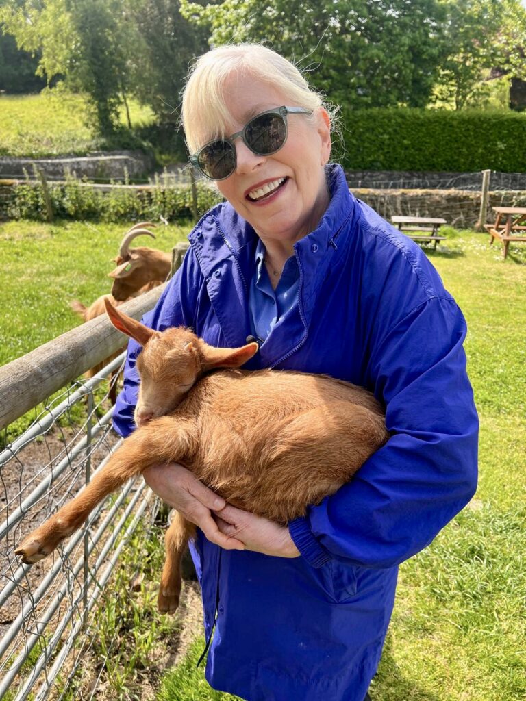 A woman holding a goat