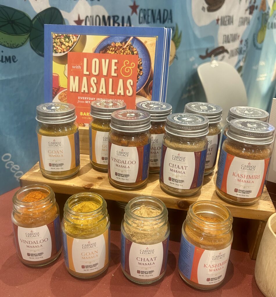 A group of jars of spices on a wooden shelf