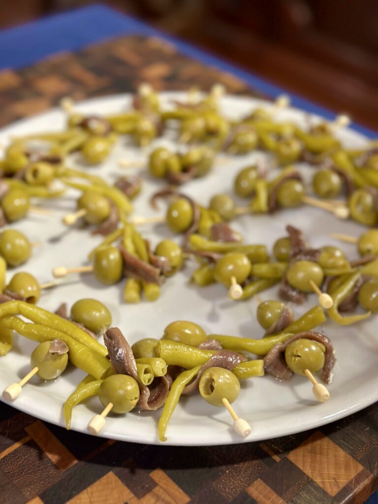 A plate of green olives and anchovies