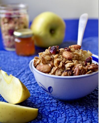 A bowl of oatmeal with nuts and fruit