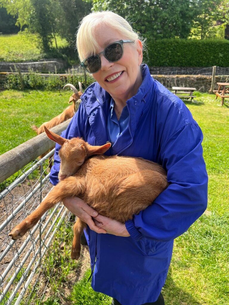 A woman holding a goat